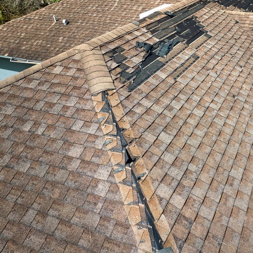 view from above of a damaged shingle roof